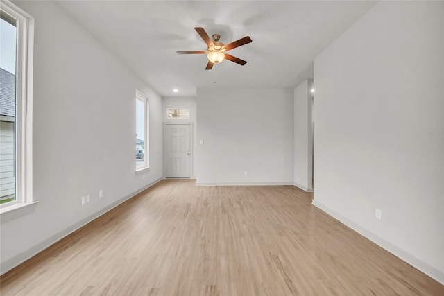 spare room featuring ceiling fan and light hardwood / wood-style flooring