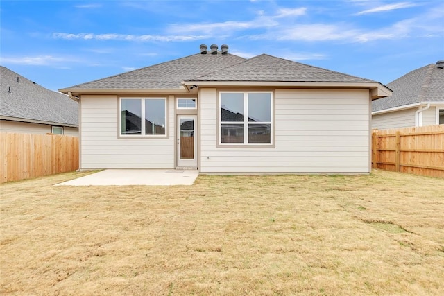 rear view of property with a yard and a patio