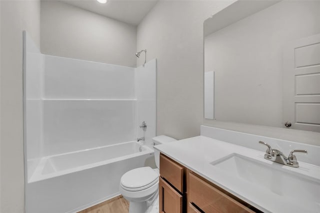 full bathroom featuring hardwood / wood-style flooring, vanity, tub / shower combination, and toilet