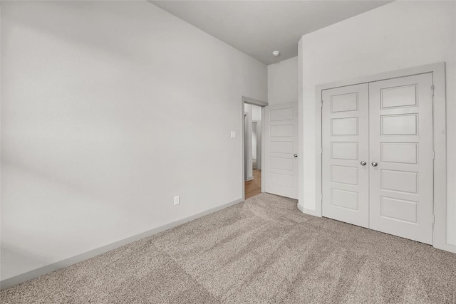 unfurnished bedroom with carpet floors and a closet