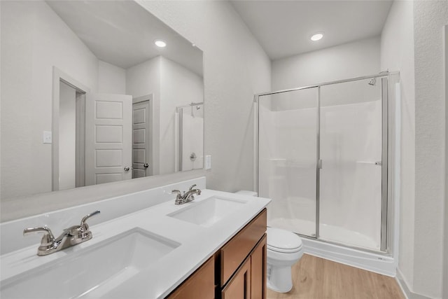 bathroom with vanity, hardwood / wood-style floors, toilet, and walk in shower