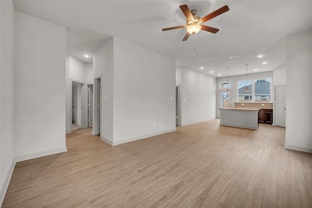 unfurnished living room with ceiling fan and light hardwood / wood-style flooring