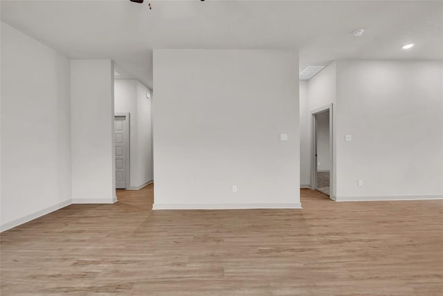 spare room featuring ceiling fan and light hardwood / wood-style flooring