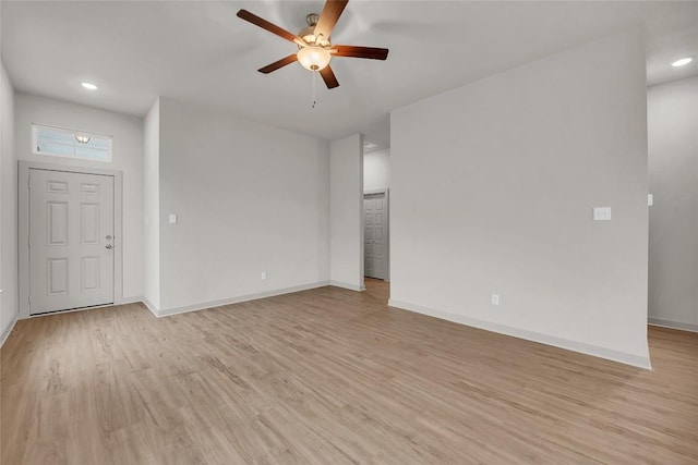 unfurnished living room featuring ceiling fan and light hardwood / wood-style flooring