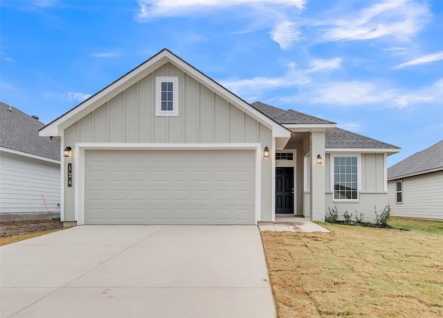 view of front of property with a garage and a front yard