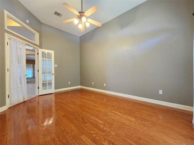 unfurnished room featuring ceiling fan, vaulted ceiling, and wood-type flooring