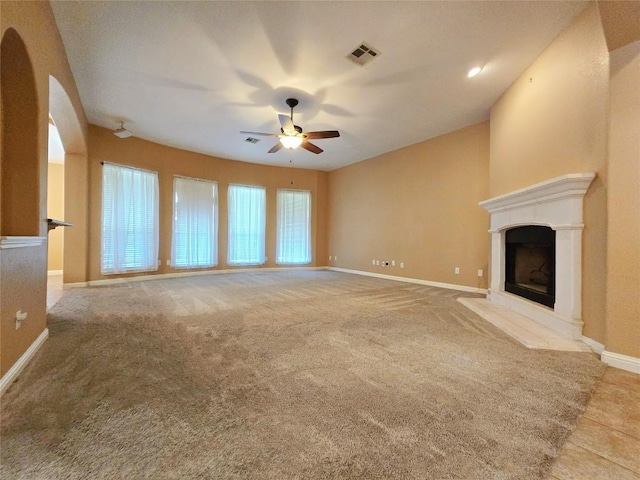 unfurnished living room featuring light colored carpet and ceiling fan