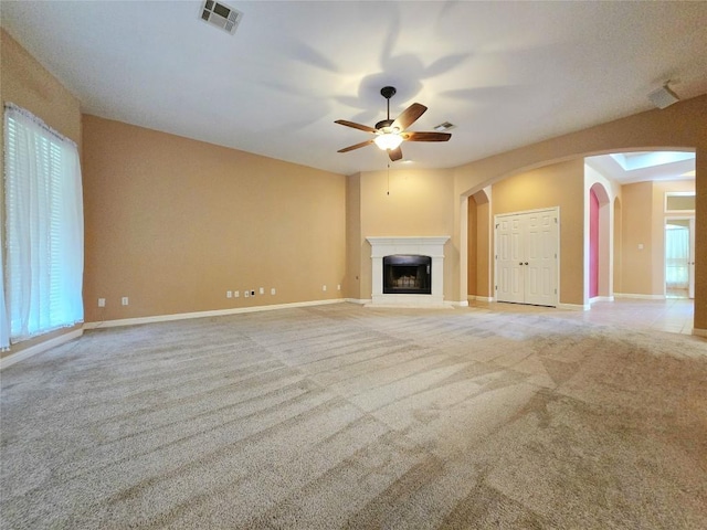 unfurnished living room with light carpet and ceiling fan