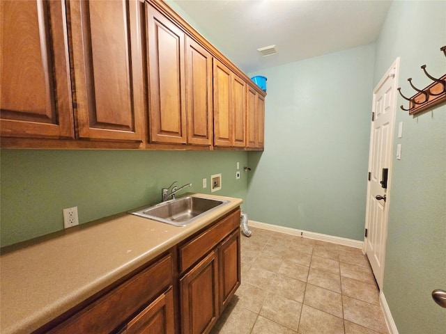 clothes washing area featuring light tile patterned flooring, cabinets, sink, and hookup for a washing machine