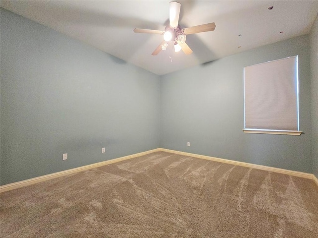 carpeted spare room with ceiling fan