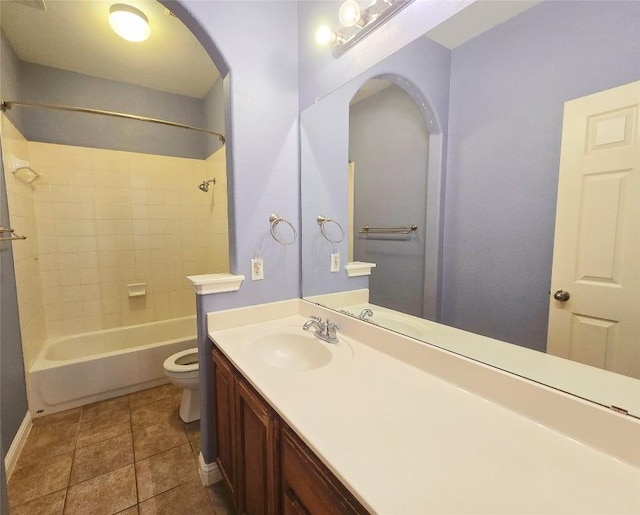 full bathroom with toilet, vanity, tile patterned flooring, and tiled shower / bath combo