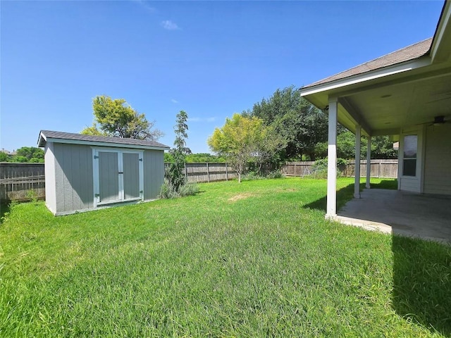 view of yard with a storage shed and a patio area