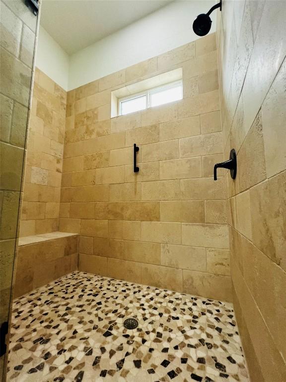 bathroom with tiled shower