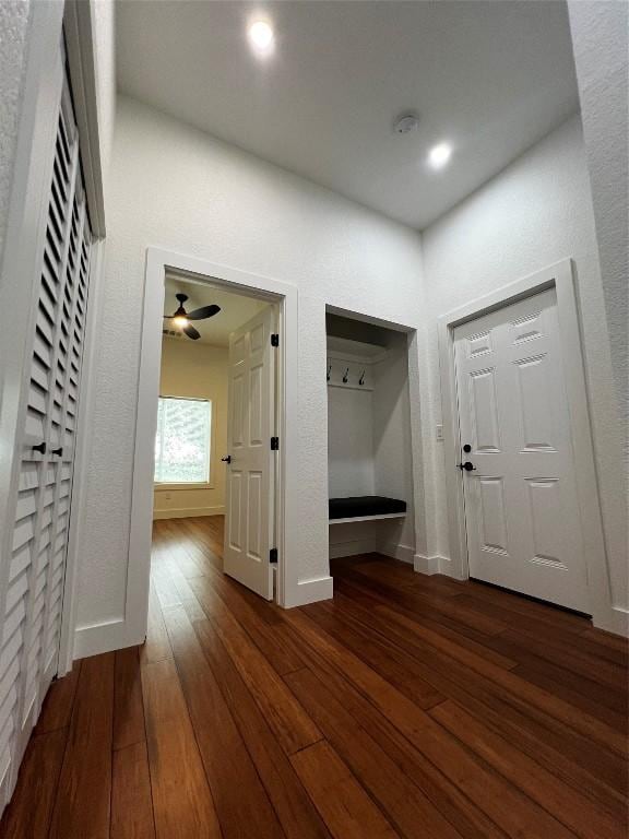 mudroom with dark wood-style floors and baseboards