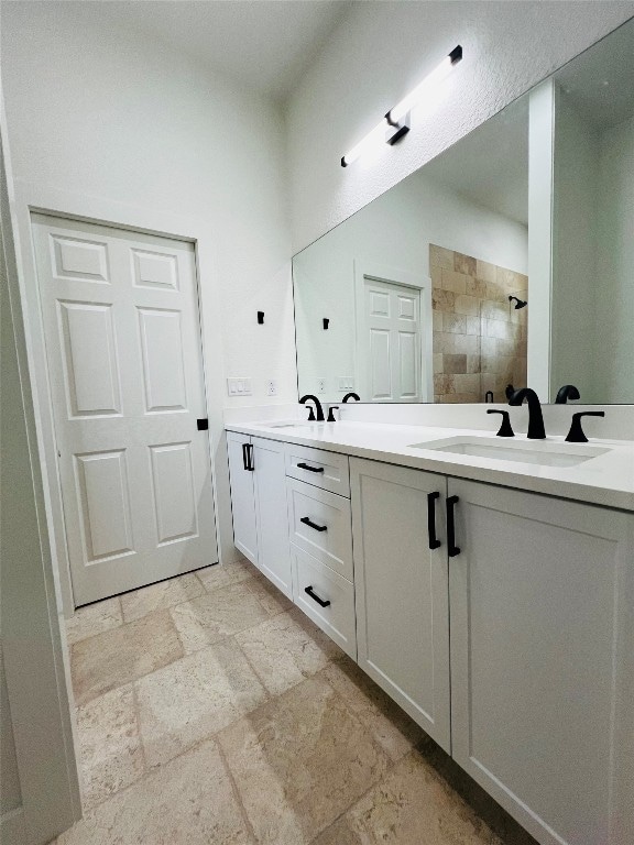 bathroom with tile patterned flooring and dual bowl vanity