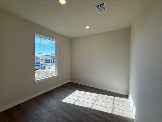 spare room with dark hardwood / wood-style flooring