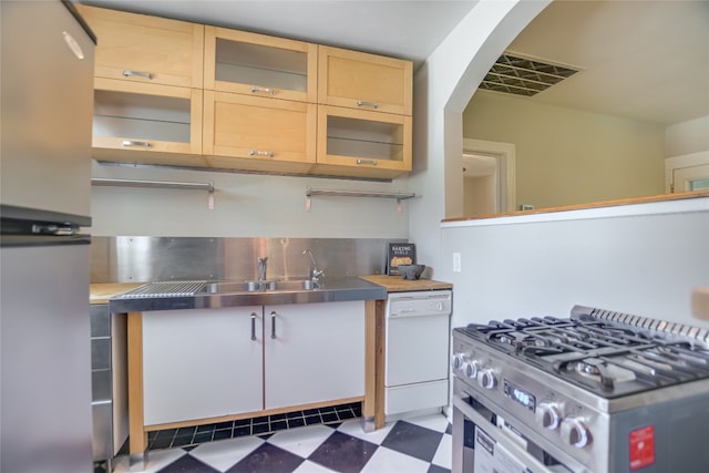 kitchen featuring dishwasher, stainless steel counters, and stainless steel gas stove