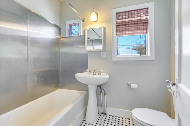 bathroom featuring tile patterned floors, shower / bathtub combination, and toilet