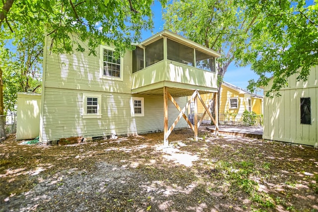 rear view of house featuring a sunroom