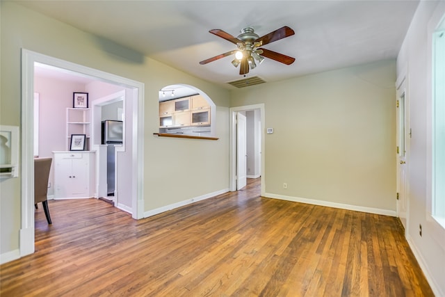 unfurnished living room with wood-type flooring and ceiling fan