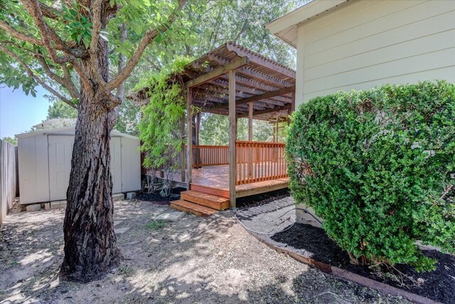 wooden terrace with a storage shed and a pergola