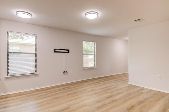 empty room with light hardwood / wood-style flooring