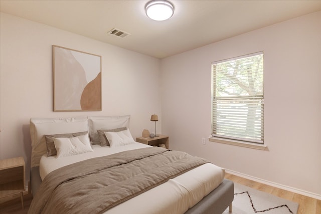 bedroom with light hardwood / wood-style floors