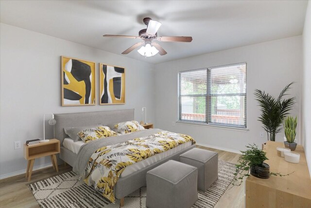 bedroom with ceiling fan and light wood-type flooring