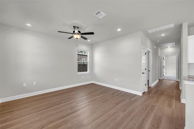 empty room featuring light wood-type flooring and ceiling fan