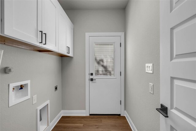 clothes washing area with light wood-type flooring, hookup for a washing machine, electric dryer hookup, and cabinets