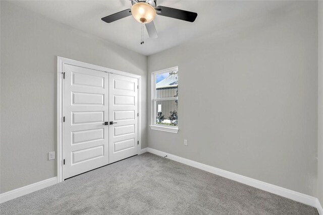 interior space featuring a closet, ceiling fan, and light colored carpet