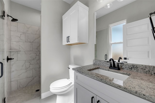 bathroom featuring tile patterned floors, a shower with door, vanity, and toilet