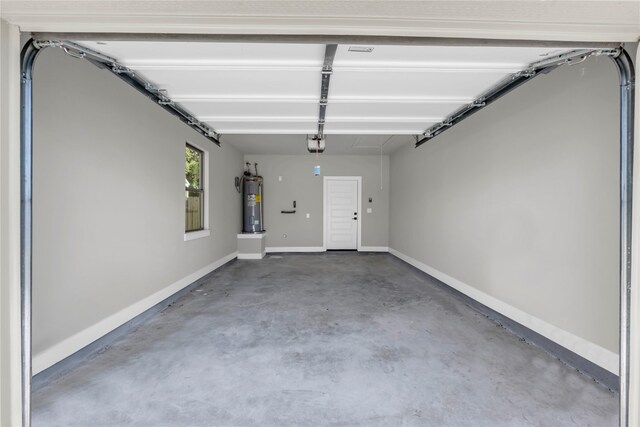 garage featuring a garage door opener and electric water heater