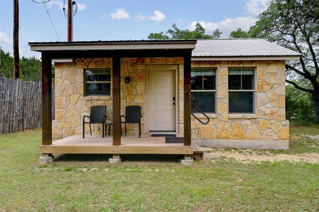 exterior space featuring a front yard and an outbuilding