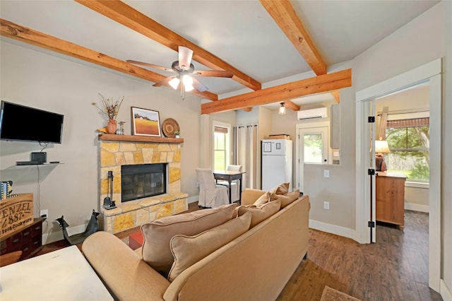 living room with hardwood / wood-style floors, ceiling fan, a wall mounted air conditioner, a fireplace, and beamed ceiling