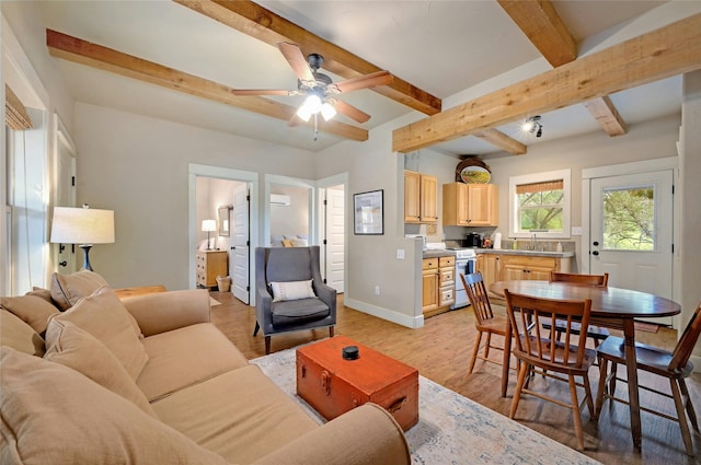 living room with ceiling fan, beam ceiling, light hardwood / wood-style flooring, and sink