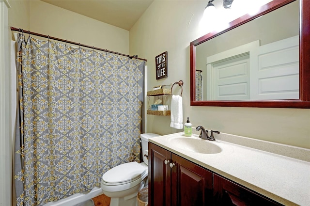 bathroom featuring toilet and vanity