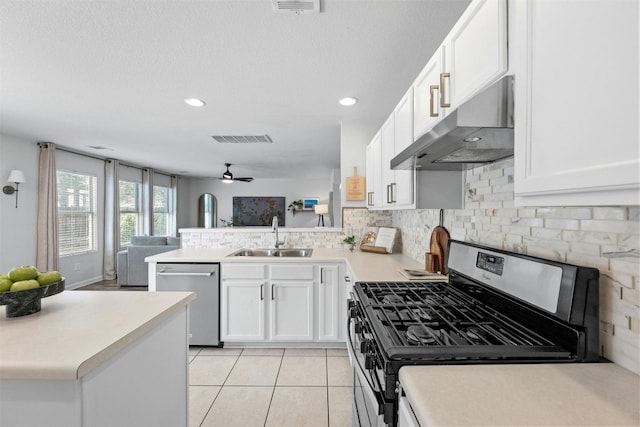 kitchen with sink, stainless steel dishwasher, ceiling fan, kitchen peninsula, and gas range oven