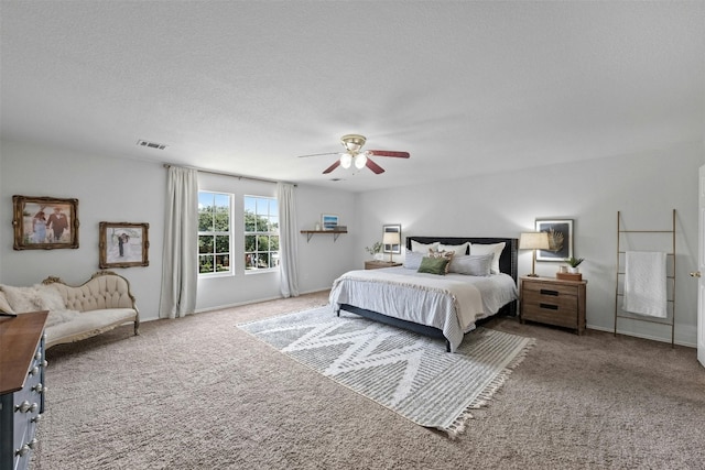 bedroom with light colored carpet, a textured ceiling, and ceiling fan