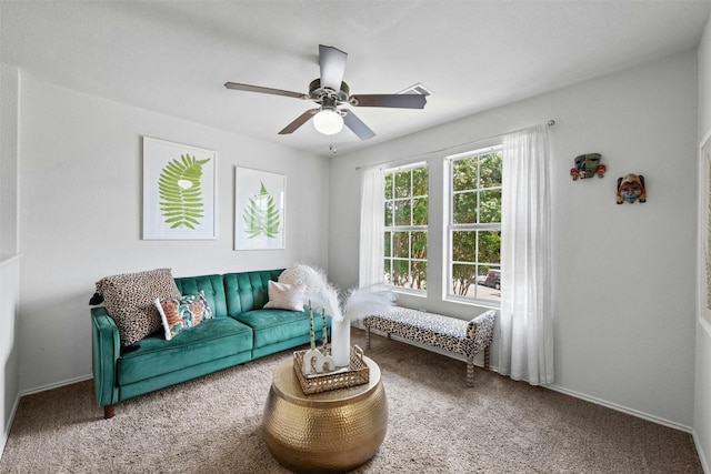 carpeted living room with ceiling fan