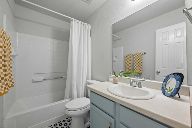 full bathroom with tile patterned floors, shower / bath combination with curtain, vanity, and toilet