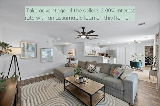 living room featuring hardwood / wood-style floors and ceiling fan