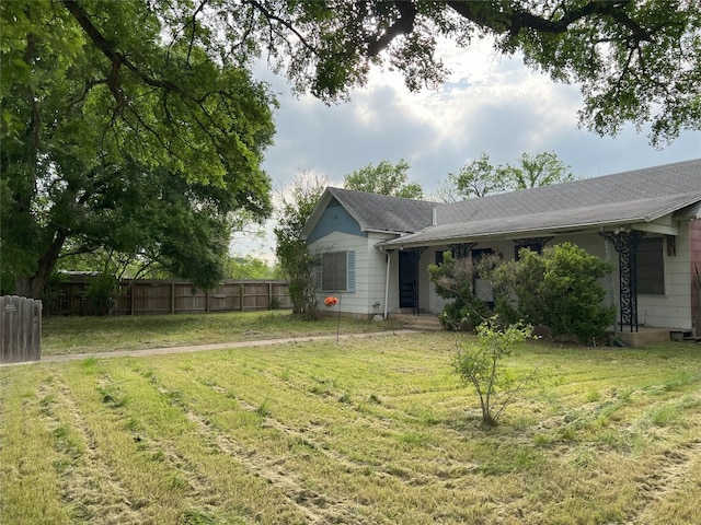 exterior space featuring fence and a front yard