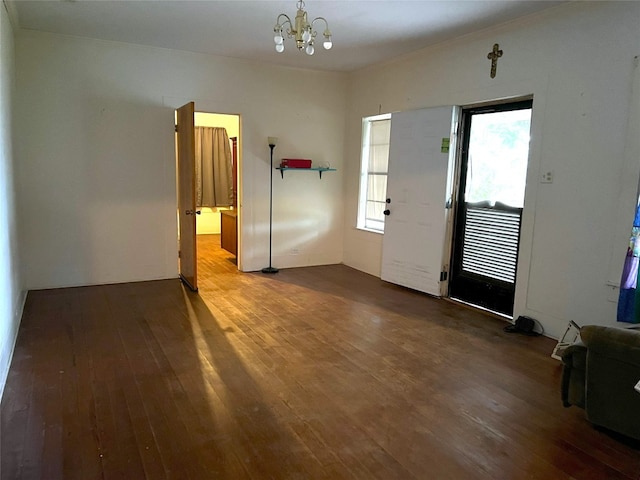 foyer with dark hardwood / wood-style floors and an inviting chandelier