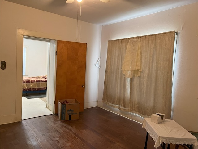 interior space with a ceiling fan and hardwood / wood-style floors
