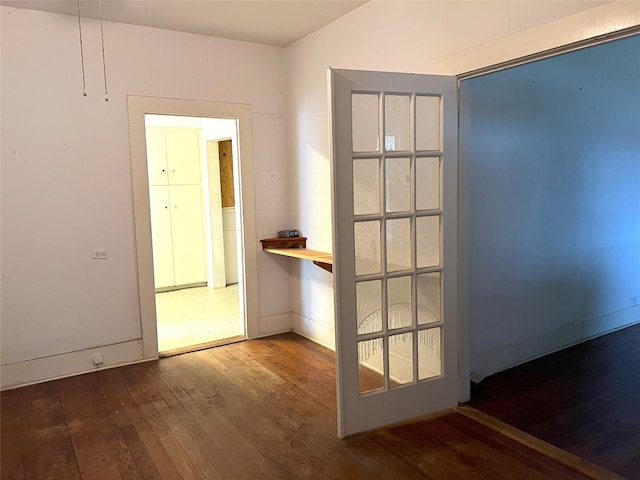 entryway featuring wood-type flooring and baseboards