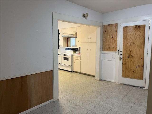 kitchen with light countertops, light tile patterned flooring, white electric stove, and under cabinet range hood