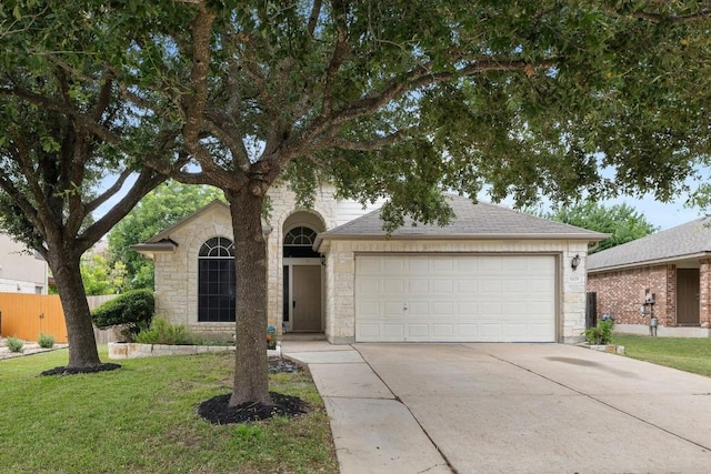 view of front of home featuring a front yard and a garage