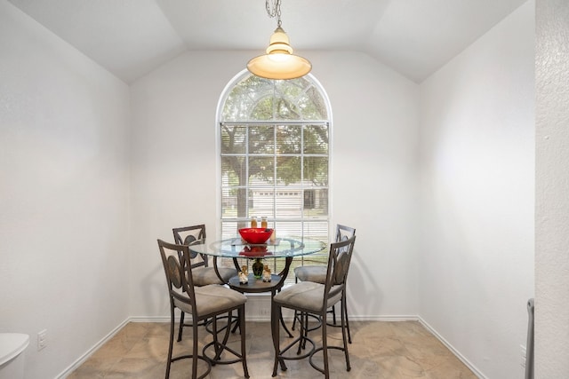 dining area with vaulted ceiling