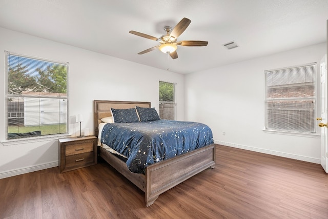 bedroom with ceiling fan and dark wood-type flooring